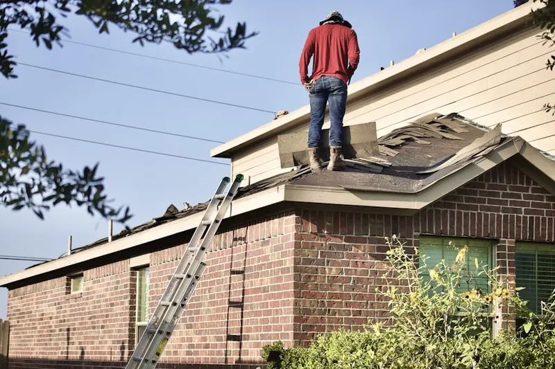 Professional roofer working on a residential roof in Rainbow City